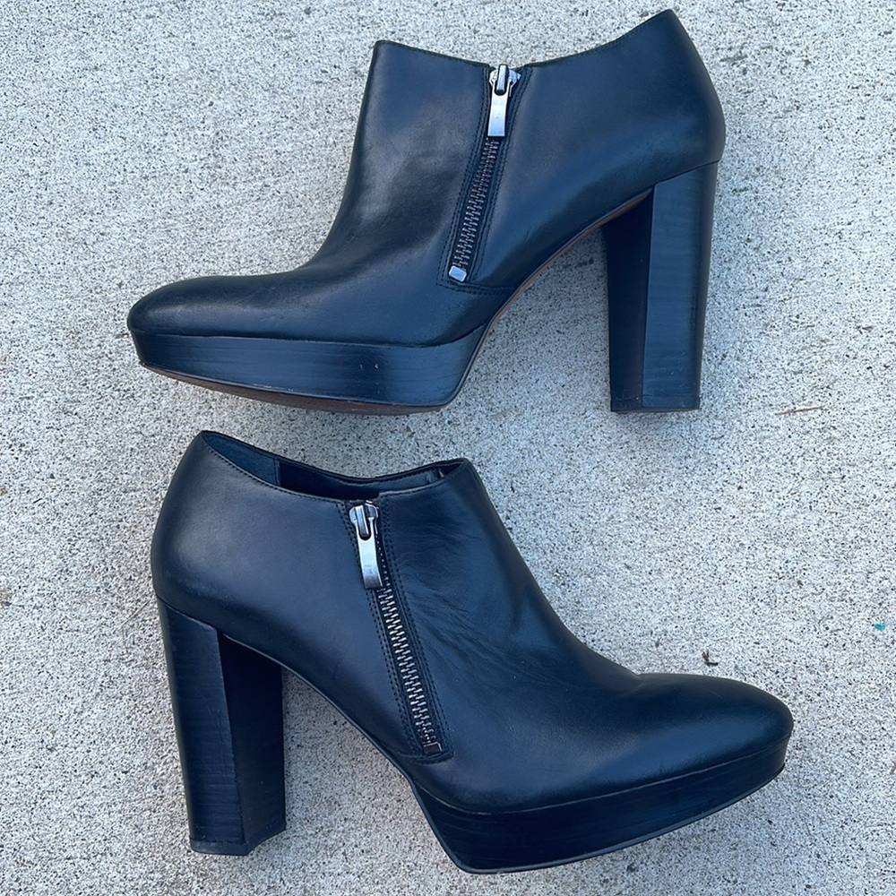 Black leather platform heal booties. Zipper closure